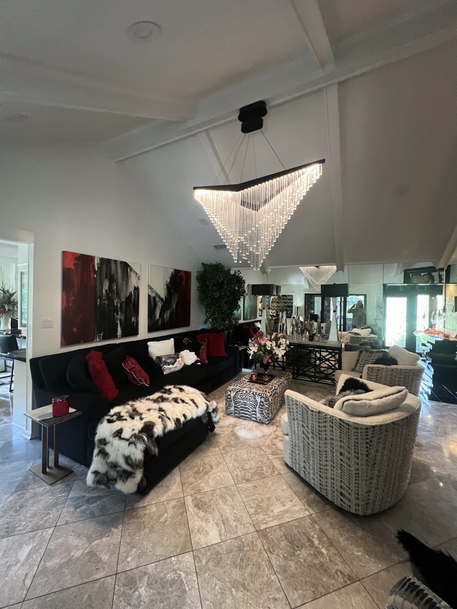 Modern crystal chandelier installed by SNS Electrical in a vaulted living room